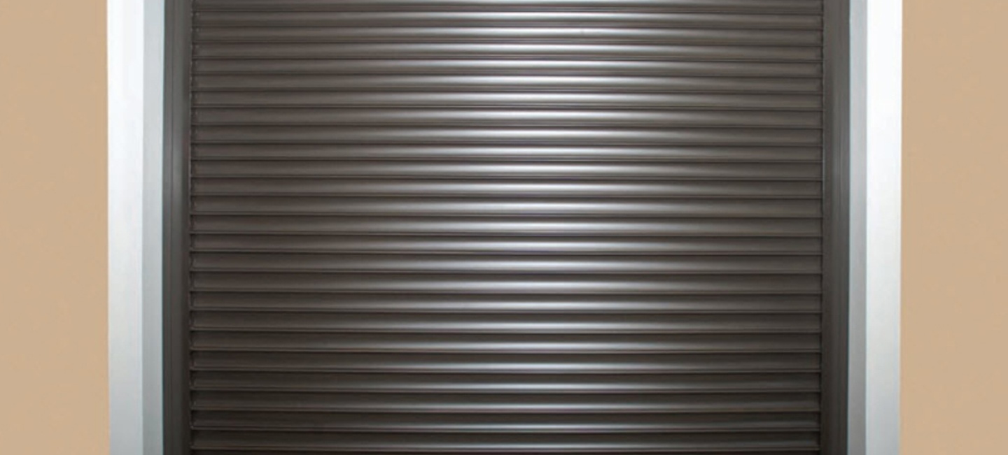 Rolling security door with a sleek, modern design, showcasing a dark, ribbed surface suitable for commercial applications, emphasizing safety and aesthetics.