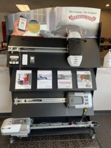 Display showcasing garage door openers and accessories in a retail setting